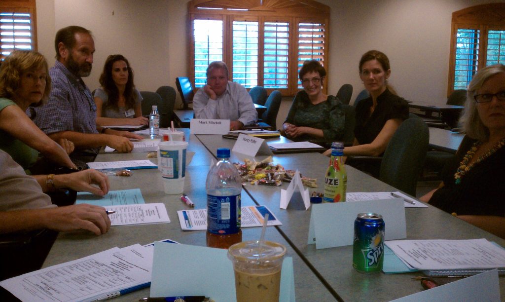 people sitting around table in board room